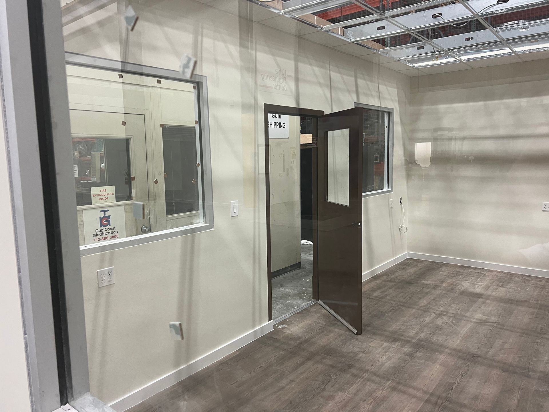 An empty room with a door and a window.