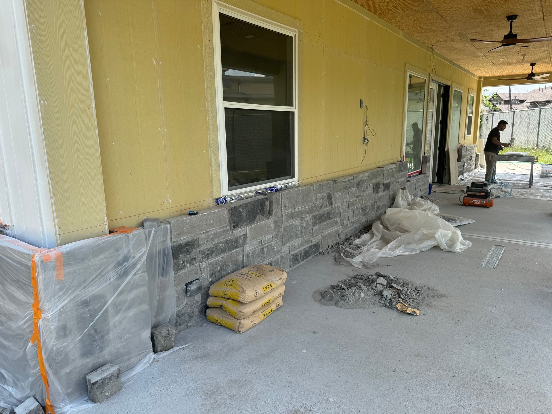 A man is working on the side of a house.