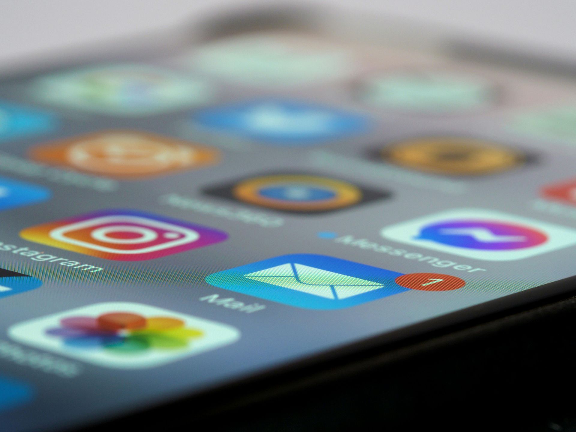 Close-up of a smartphone screen displaying app icons, including Instagram, Mail, and Messenger.