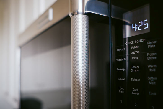 Close-up of a Black Microwave With a Silver Handle — NatureWise Pest Control In Port Macquarie, NSW