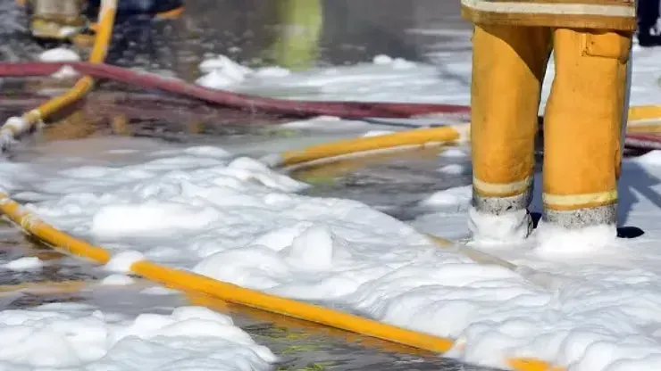 Firefighter's Yellow Boots in White Foam, With Yellow and Red Hoses — NatureWise Pest Control In Port Macquarie, NSW