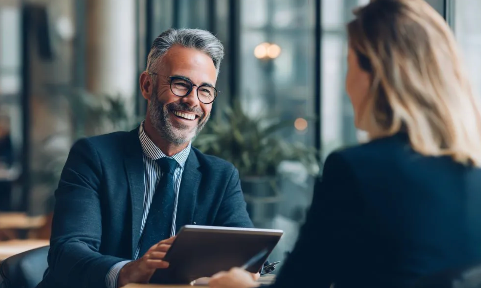 Smiling businessman in meeting with colleague.