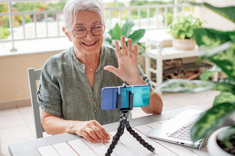 senior woman recording video senior woman influencer recording a video with her smart phone
