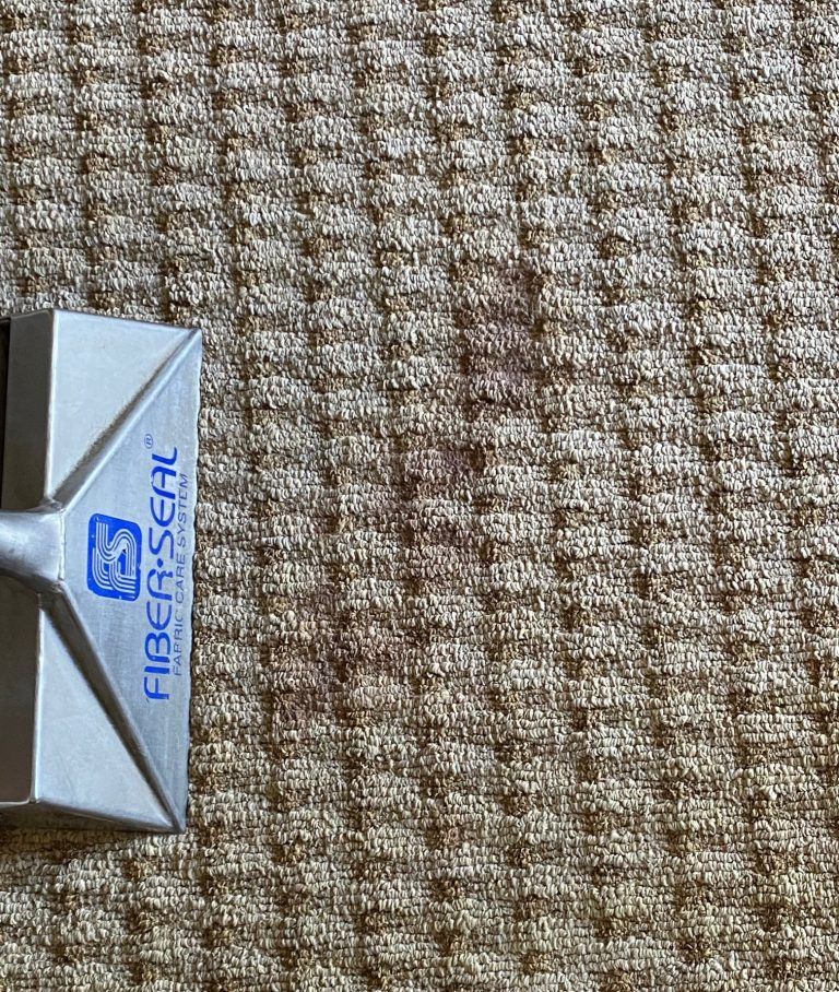 A fiber seal tool is sitting on top of a brown carpet.