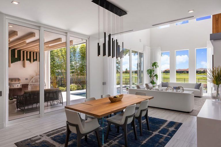 A man is spraying a couch with a spray bottle.