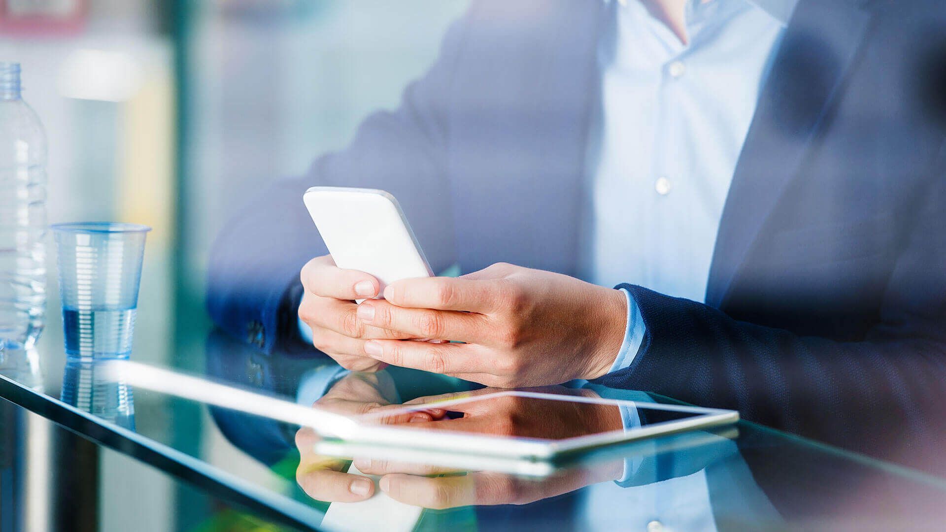 A man's hands hold a smart phone.
