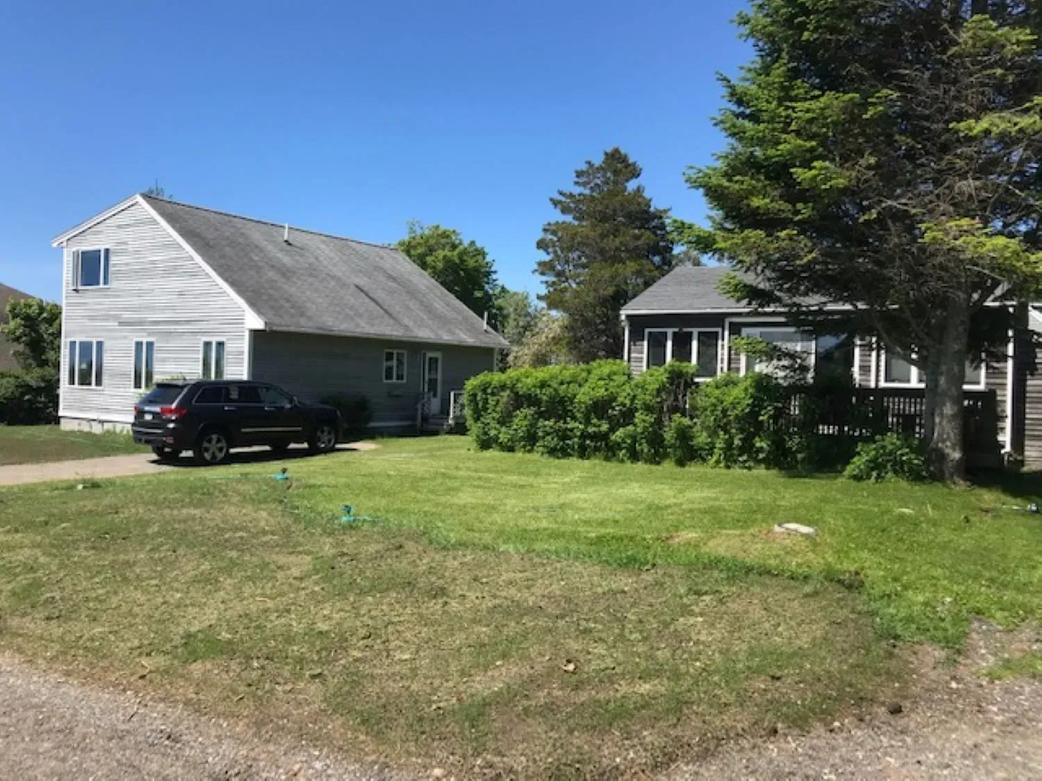 A black suv is parked in front of a house