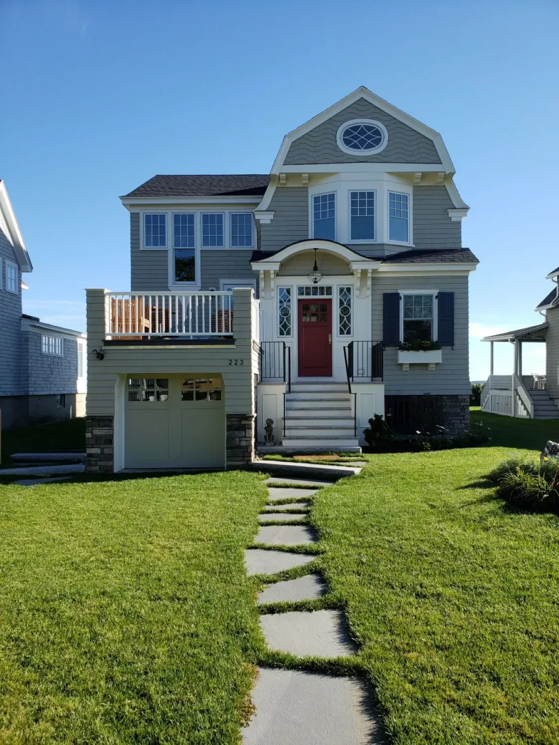 A large house with a red door and a walkway leading to it