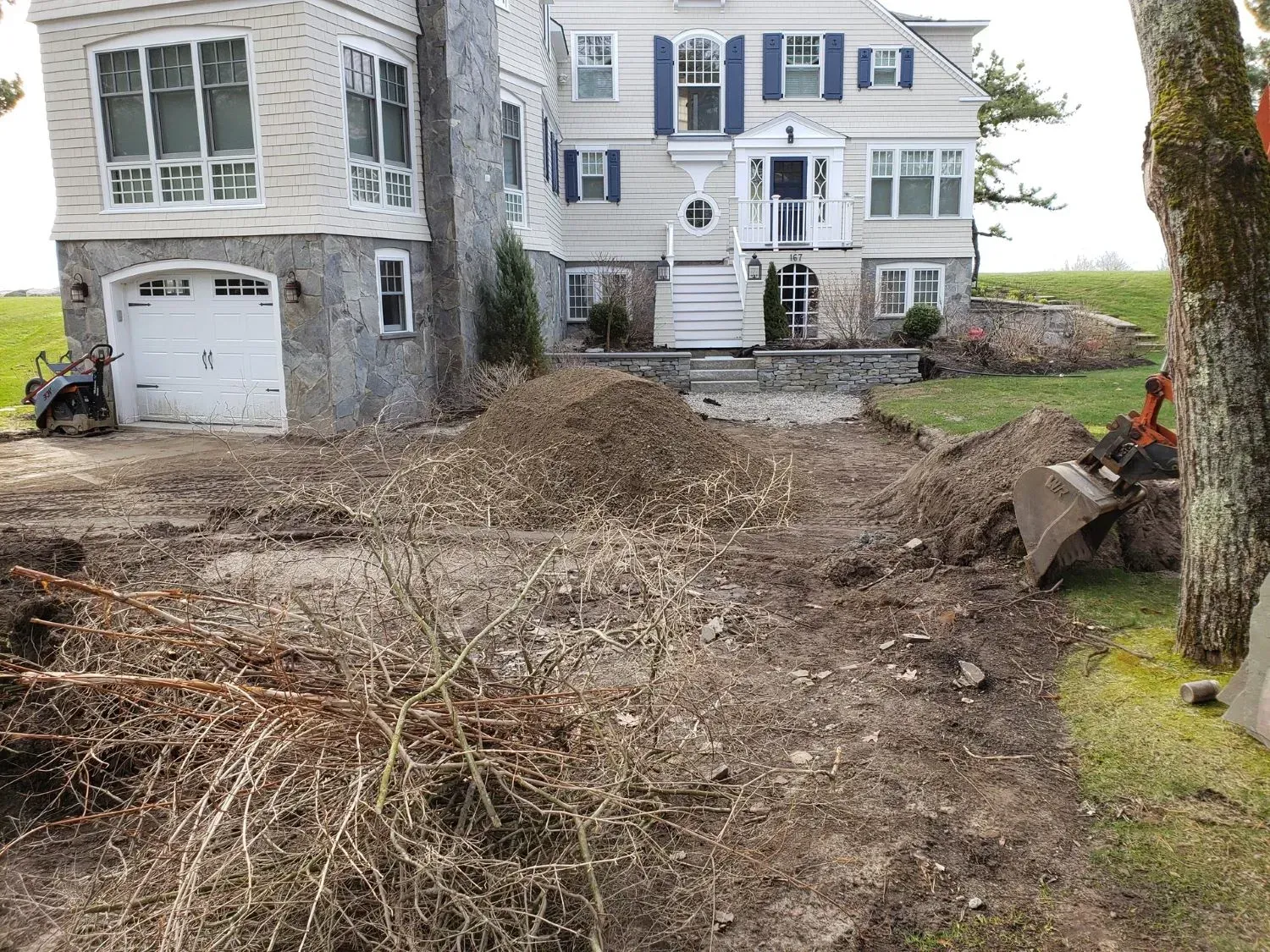 A large house with a lot of dirt in front of it.