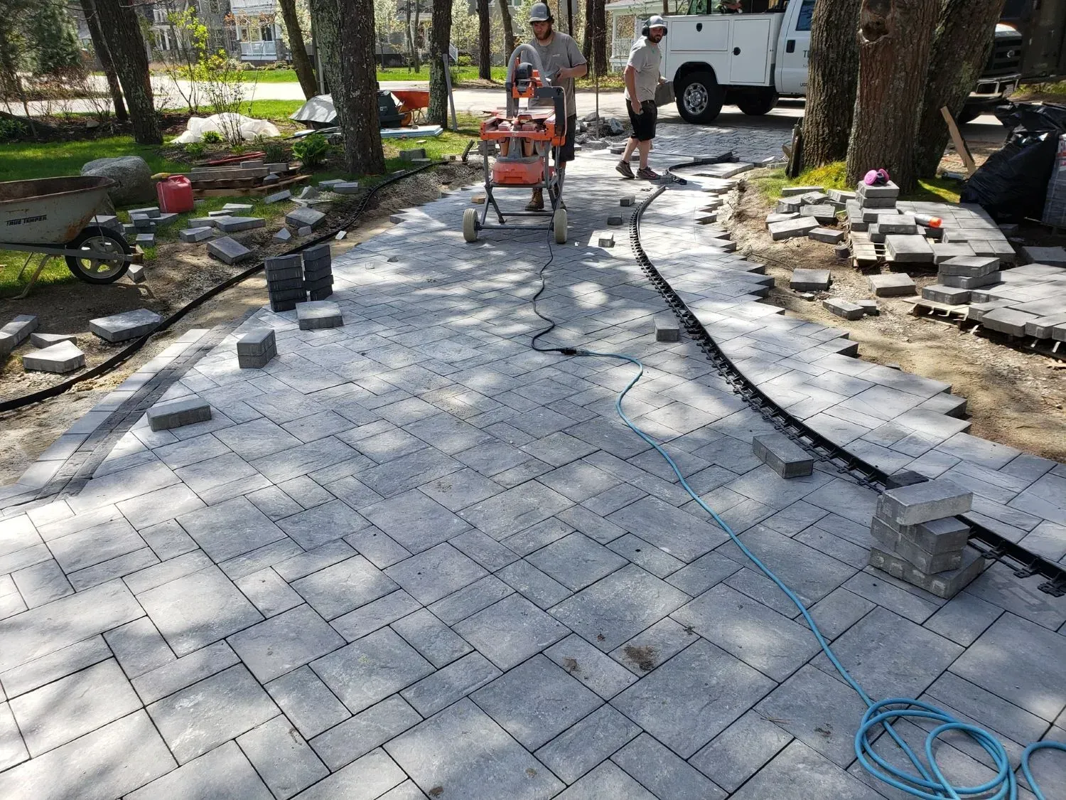 A group of people are working on a patio.