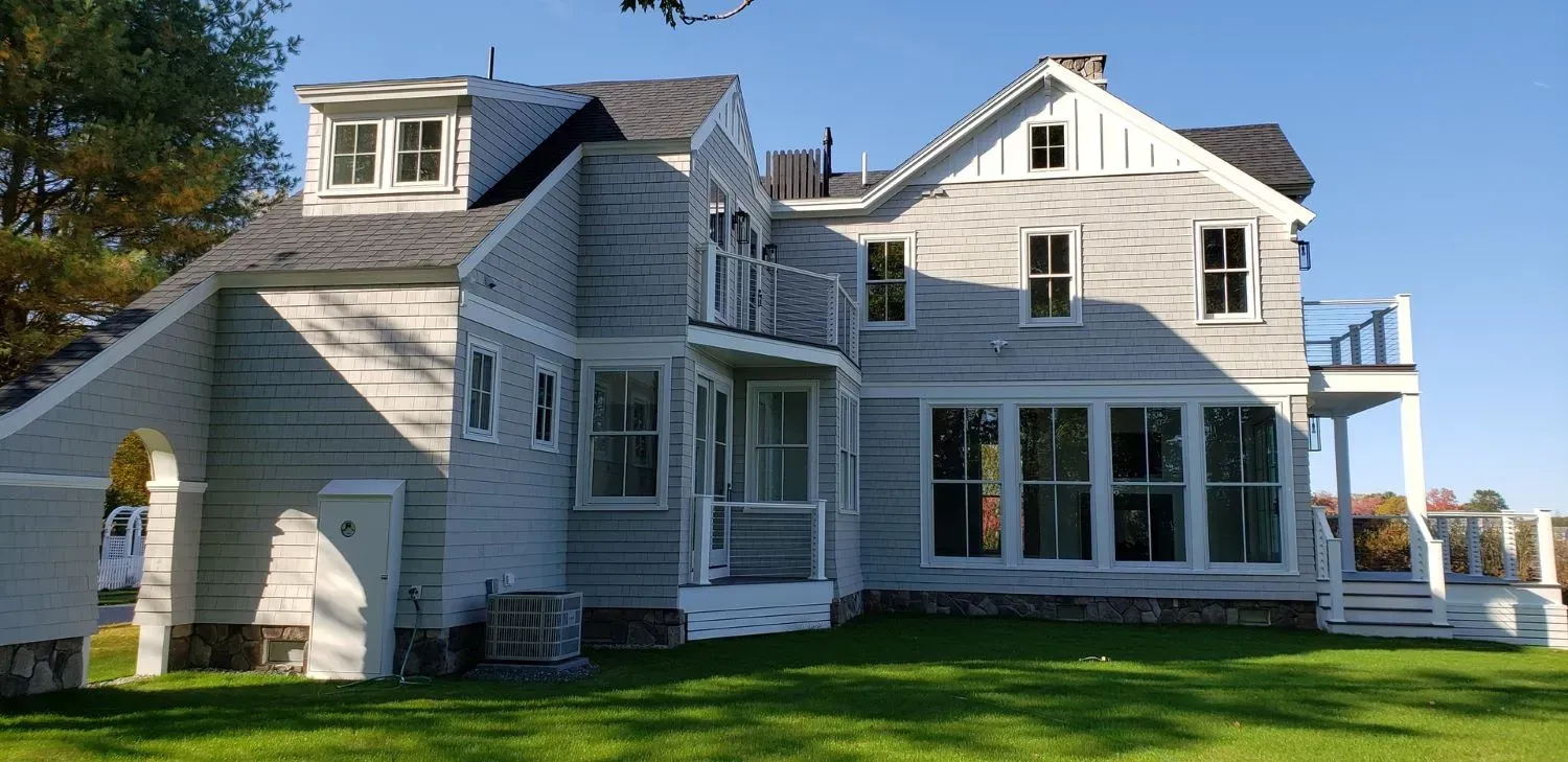 A large white house with a lot of windows and a porch