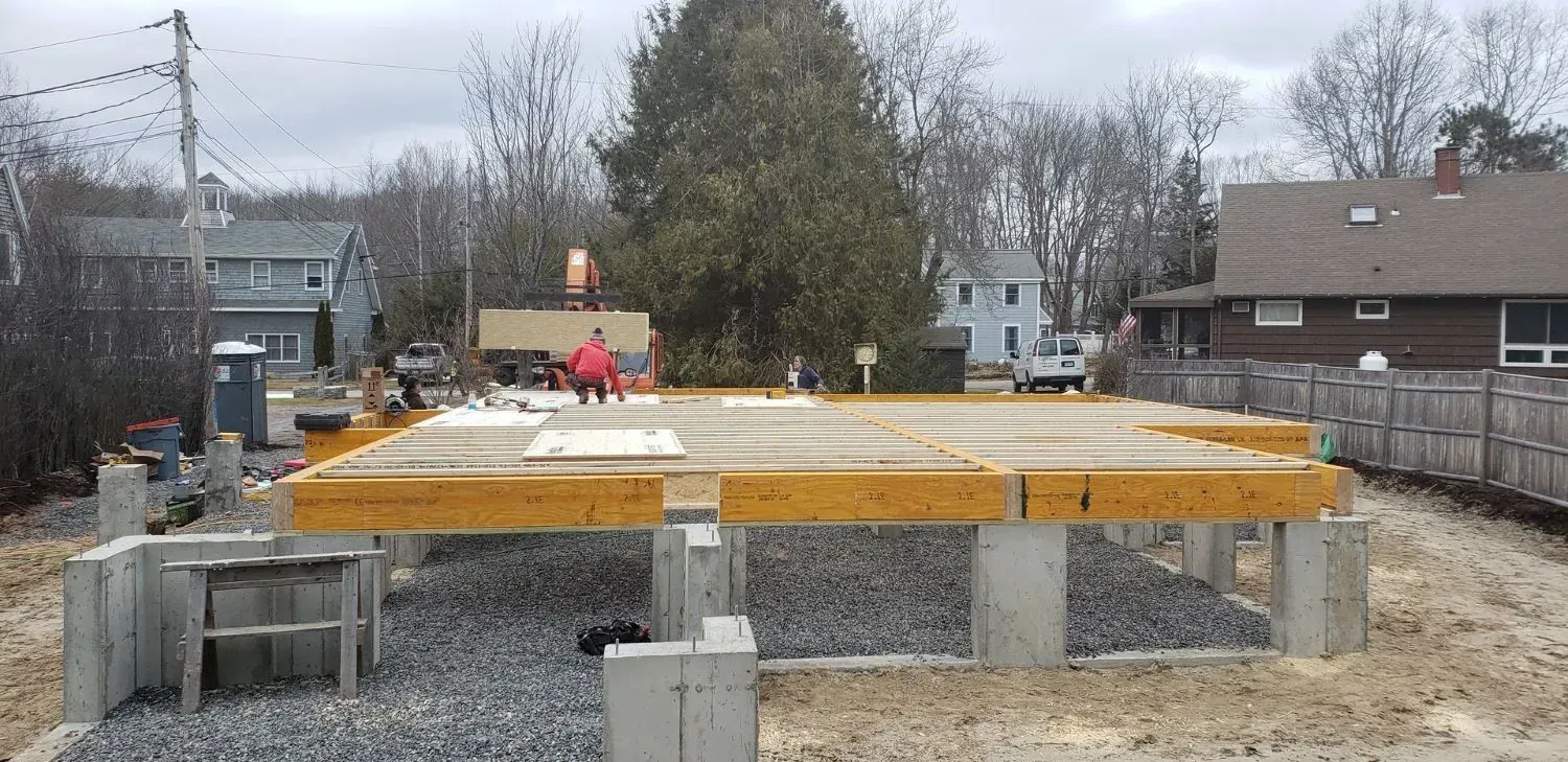A construction site with a house in the background