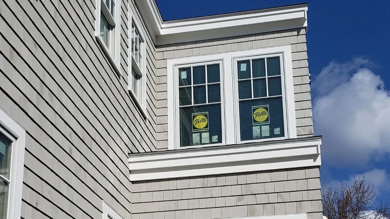 A house with a lot of windows and a blue sky in the background.