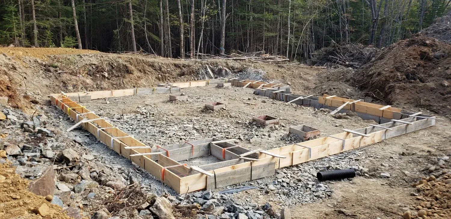 A large pile of dirt and rocks is sitting in the middle of a dirt field.