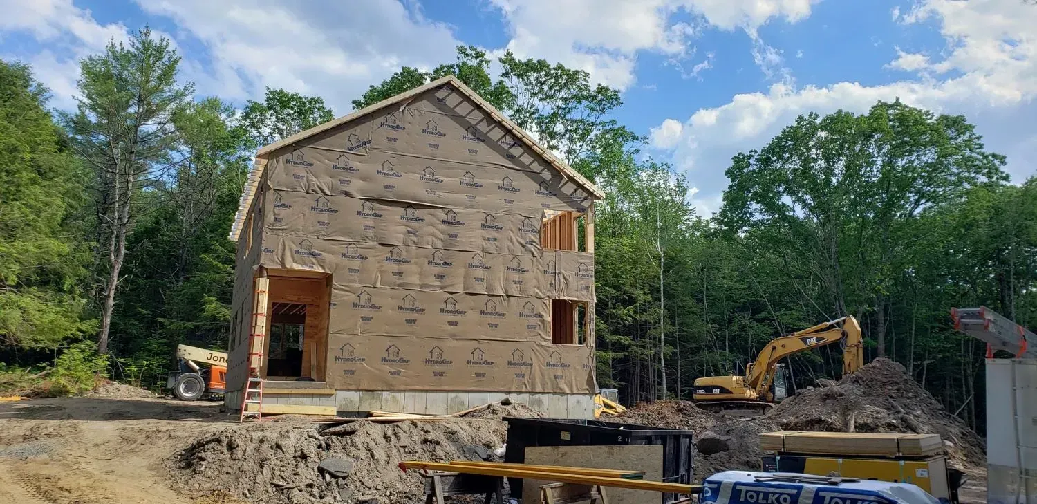 A house is being built in the middle of a forest.