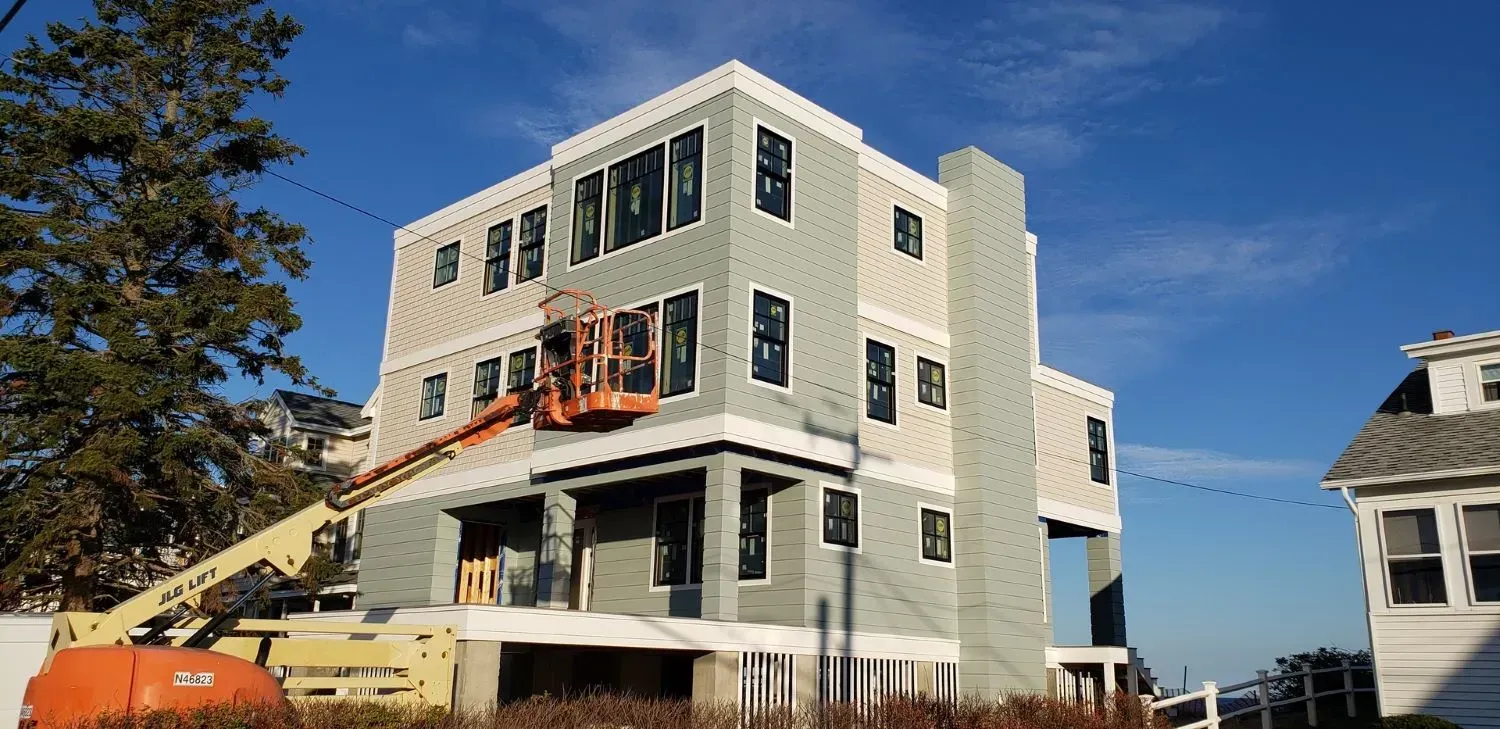 A large building is being built with a crane on top of it.