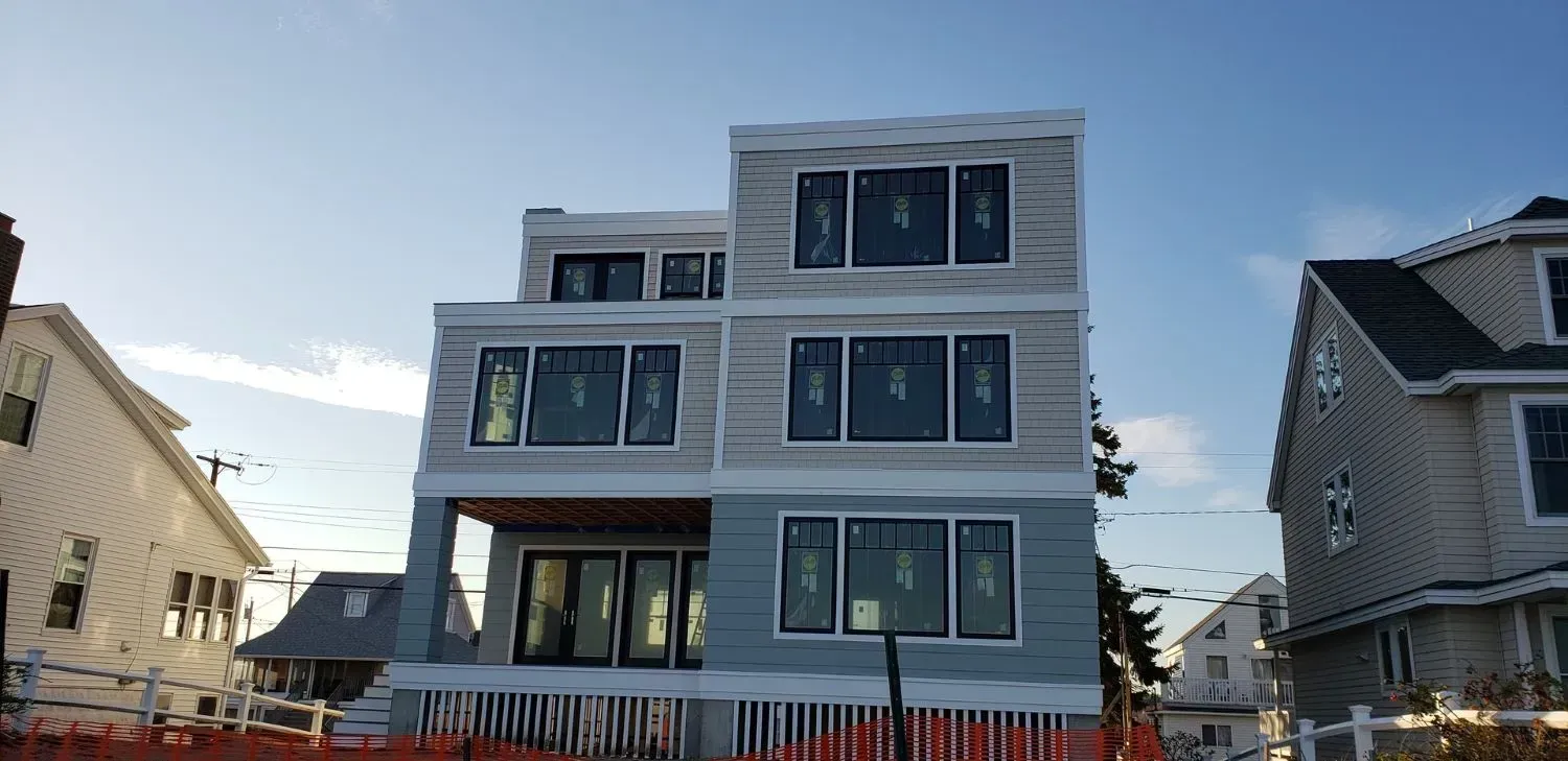 A large house with a lot of windows is being built.