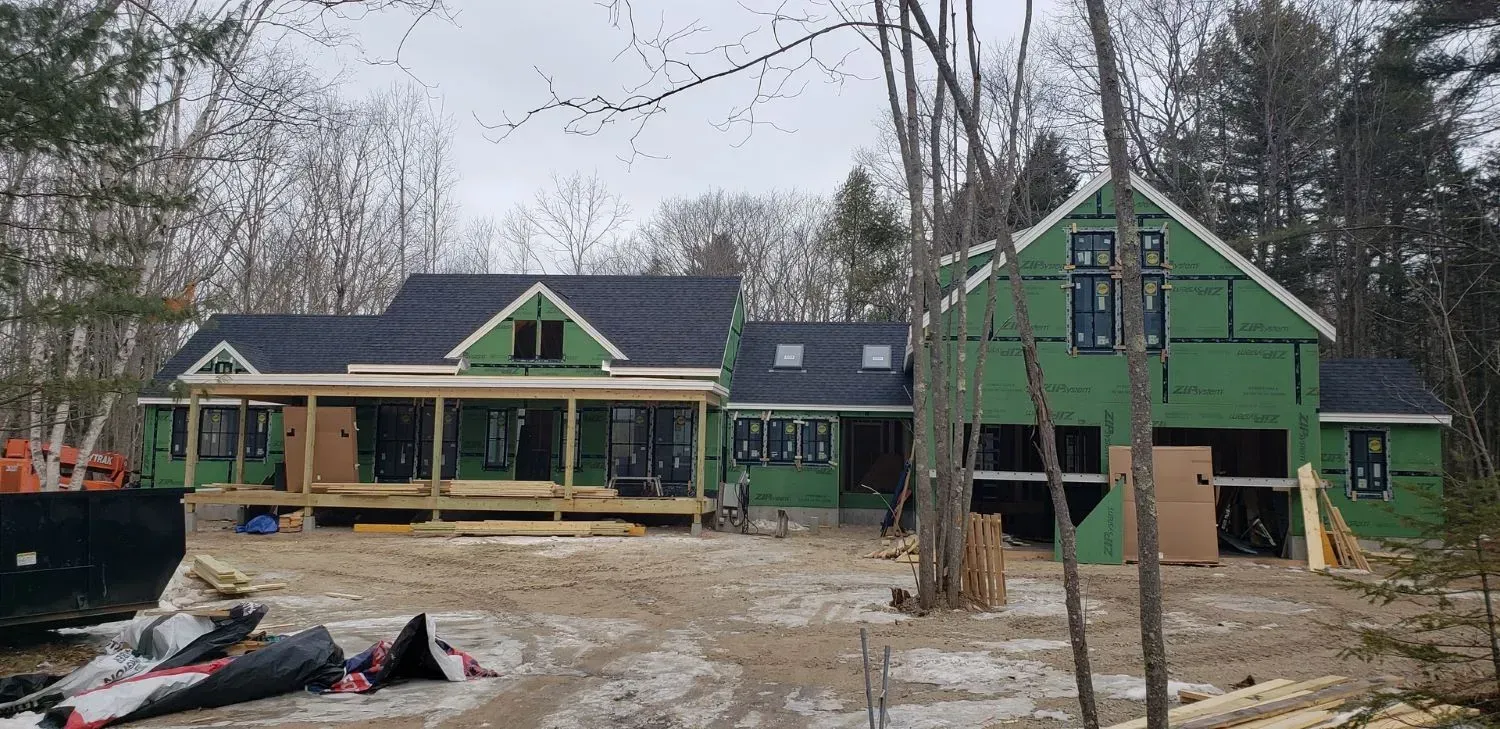 A large house is being built in the middle of a forest.