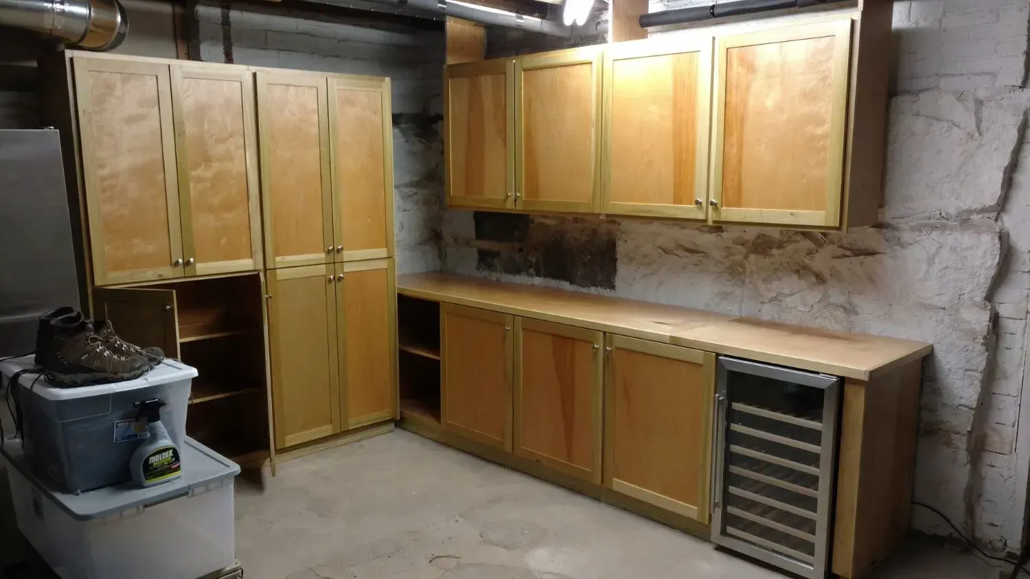 A kitchen with wooden cabinets and a wine cooler