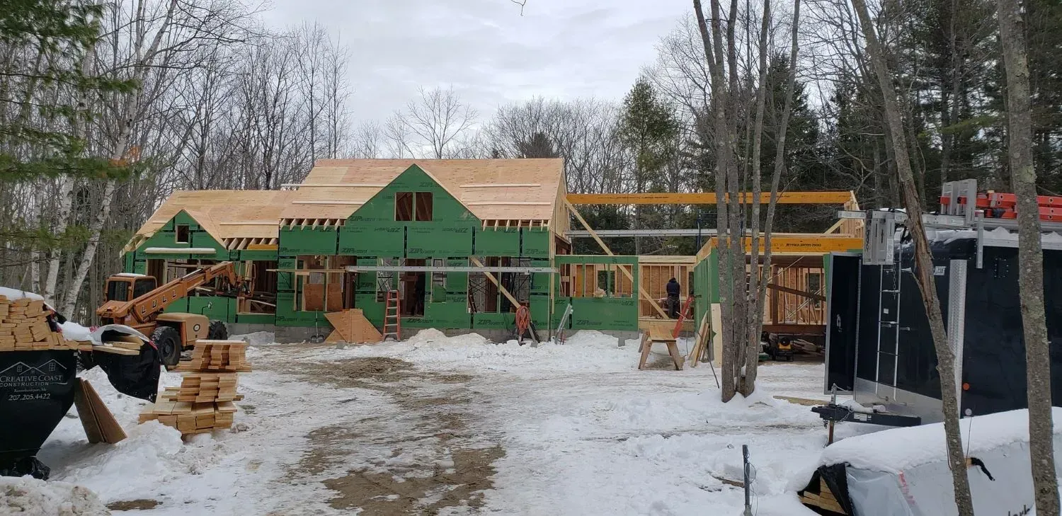 A large house is being built in the snow.