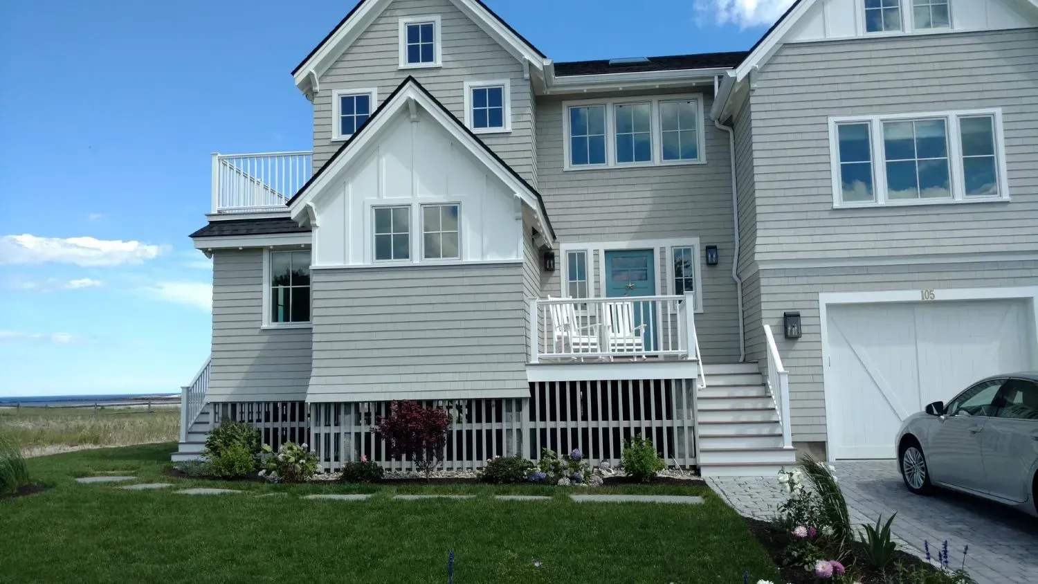 A large house with a car parked in front of it