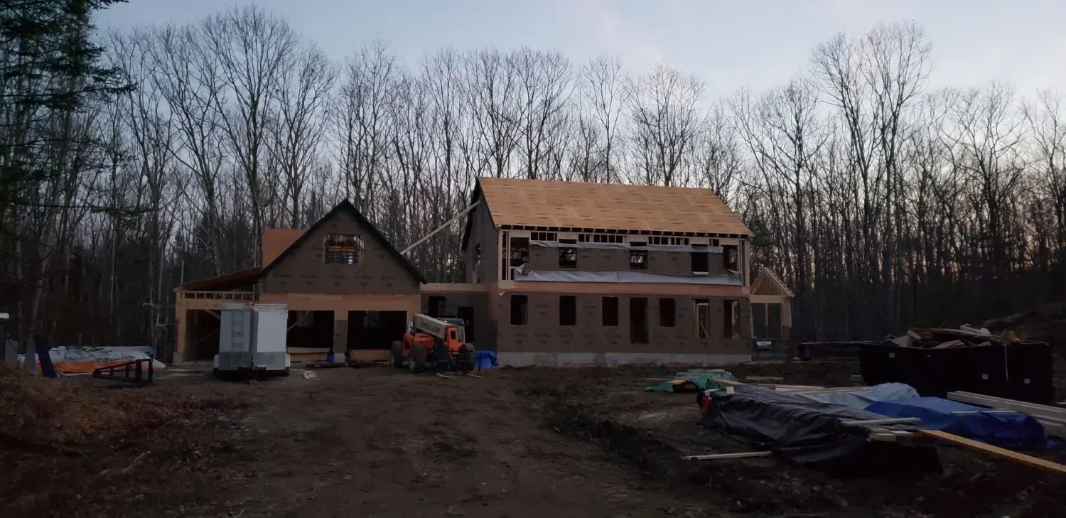 A large house is being built in the middle of a forest.
