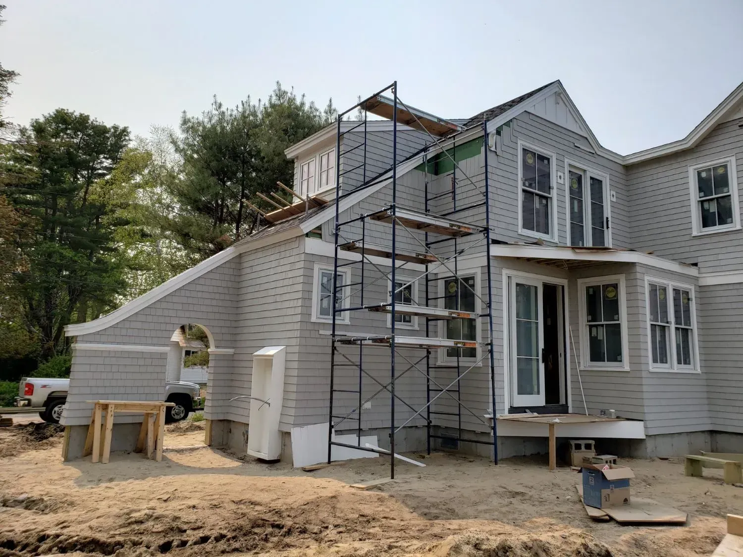 A large house is being remodeled with scaffolding around it.