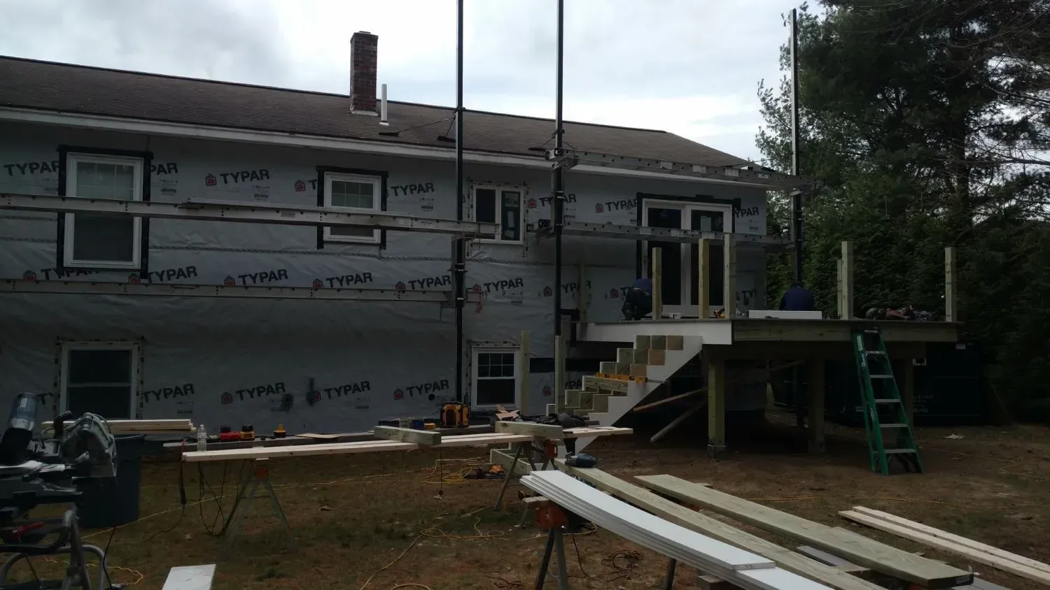 A house is being remodeled with a deck and stairs