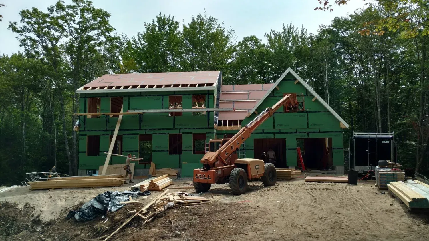 A large house is being built in the middle of a forest.