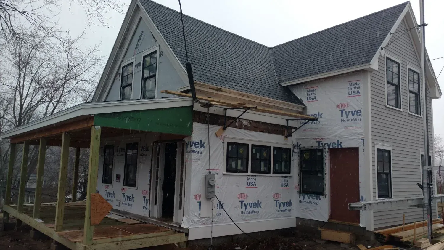 A house is being built with a porch and a roof.