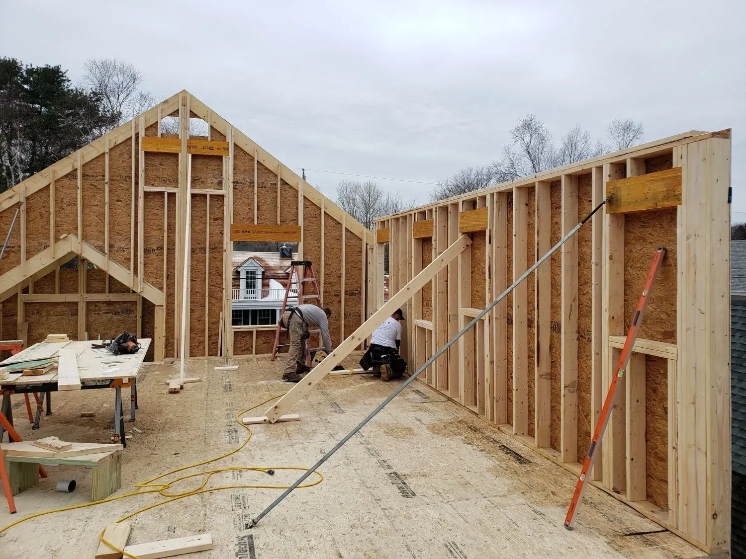 A group of men are working on a wooden structure.