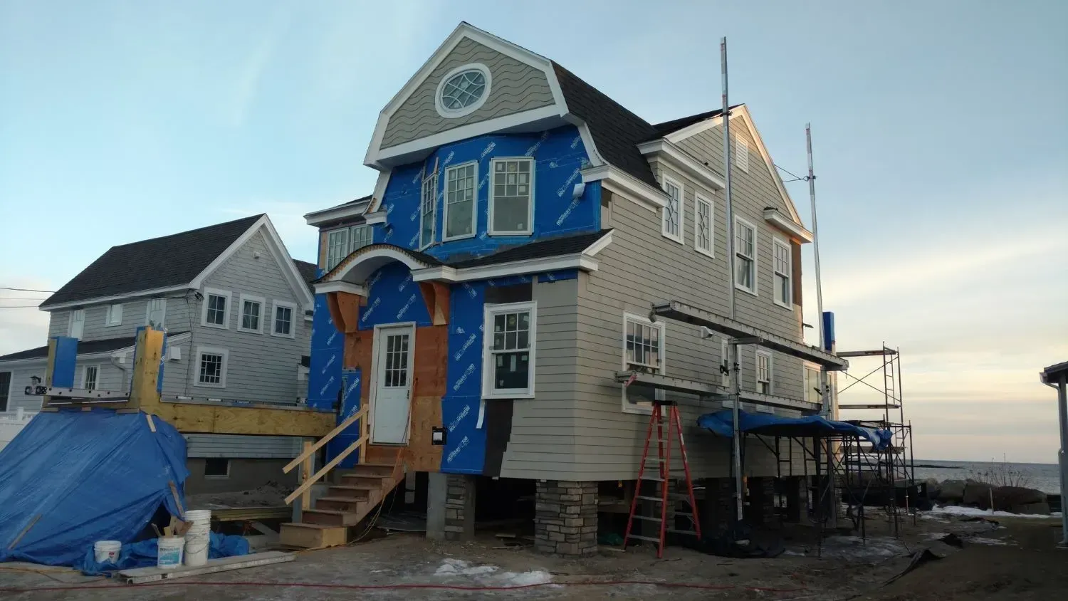 A house that is being built with a blue roof