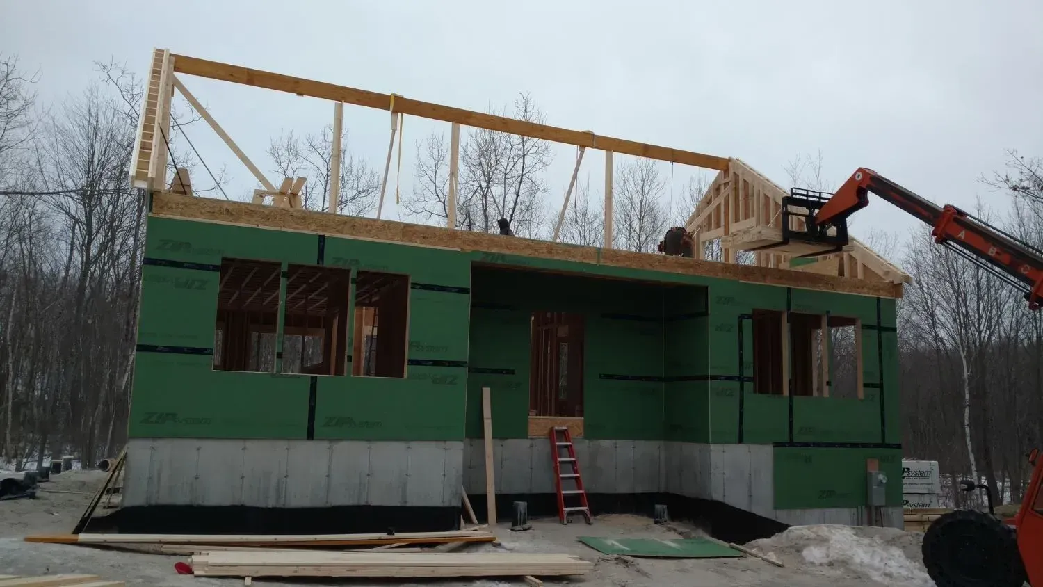 A house that is being built with a crane on top of it