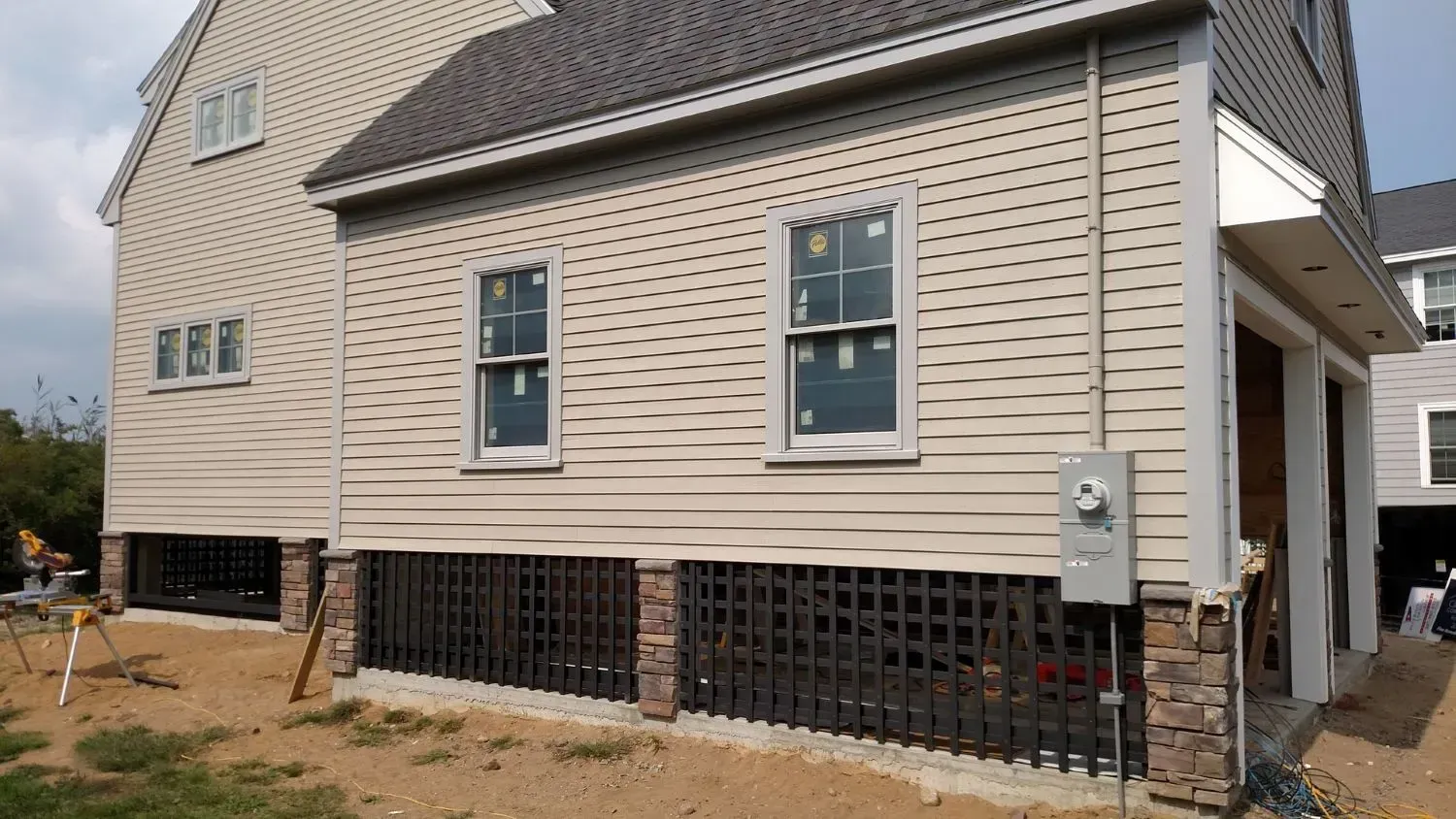 A house with a garage underneath it is being built.