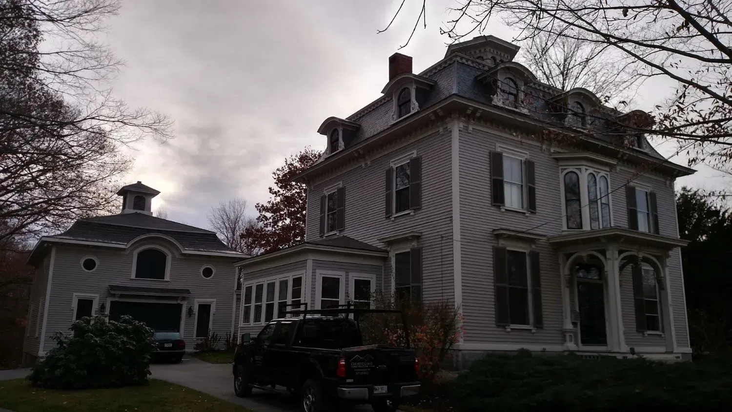 A large house with a truck parked in front of it