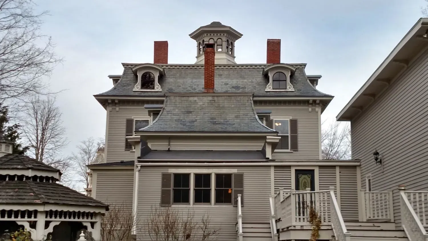 A large house with a gazebo in front of it