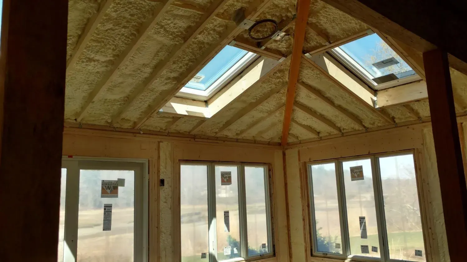 A room with a lot of windows and skylights on the ceiling.