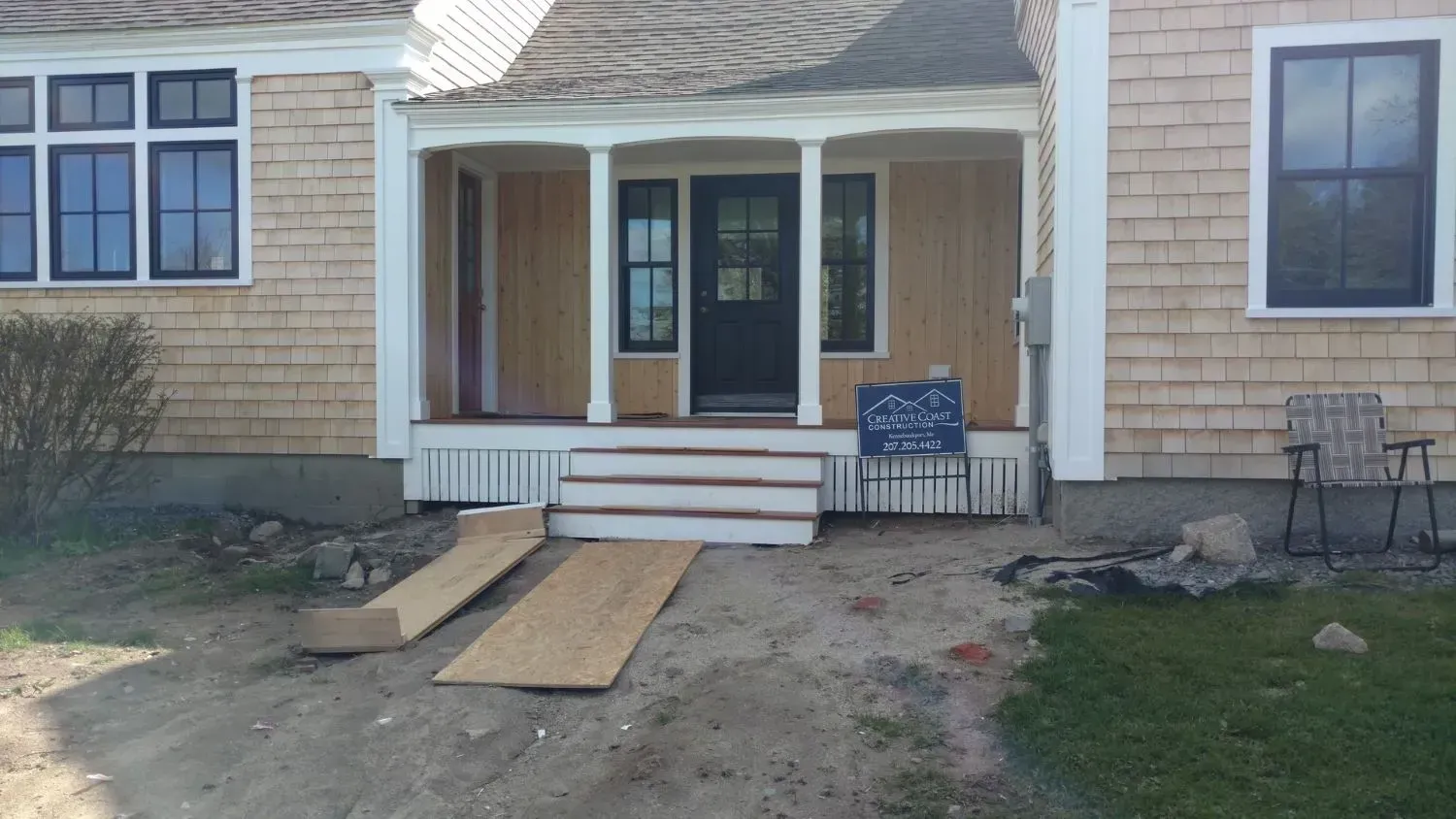 A house with a porch and stairs being built