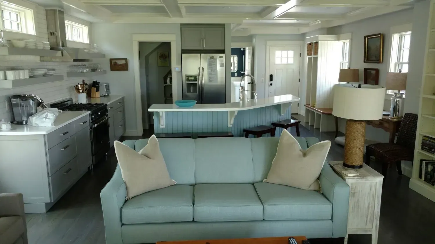 A living room with a couch and a lamp