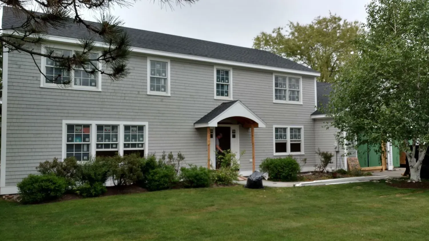 A large house with a lush green lawn in front of it.