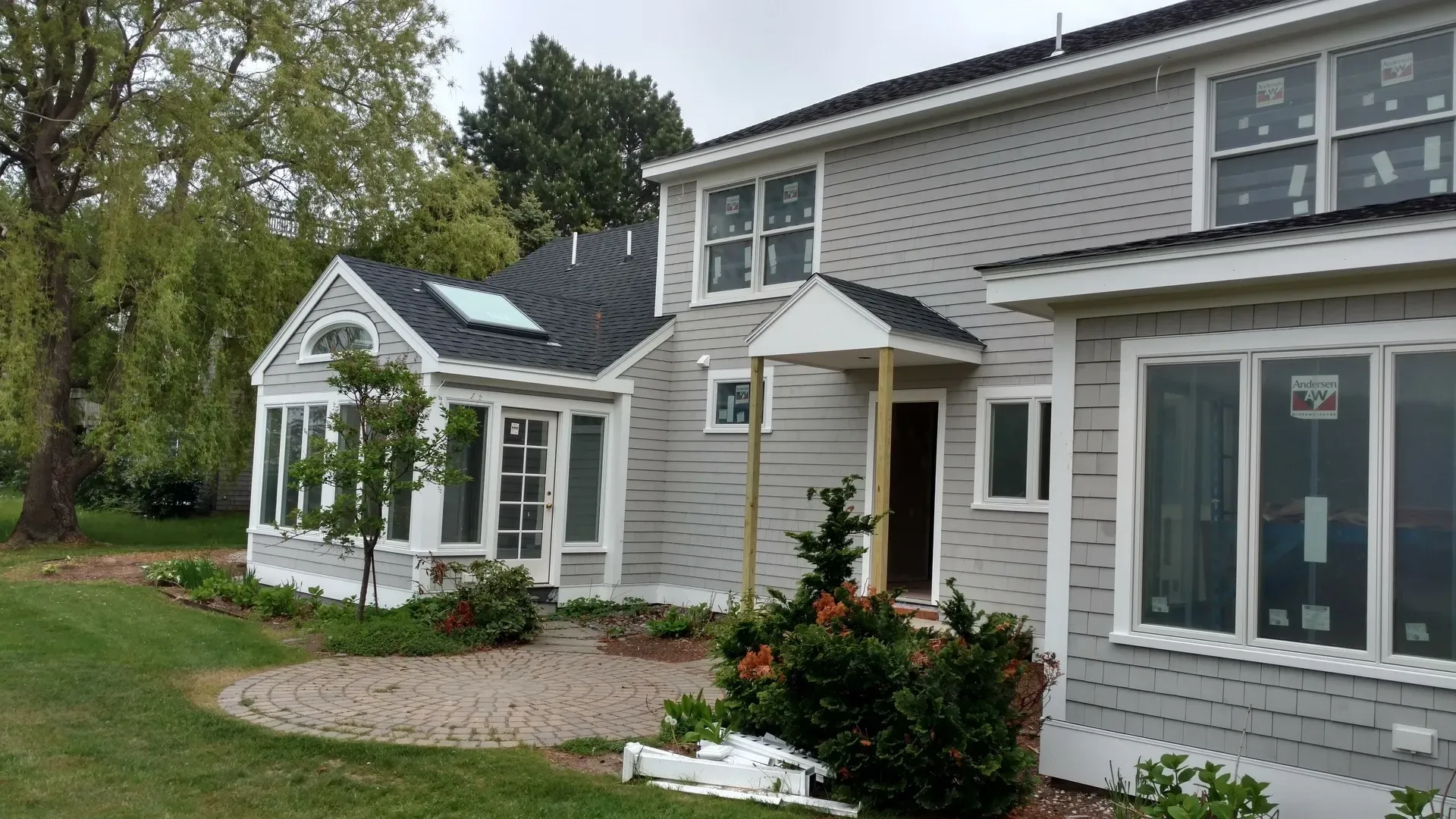 A large house with a lot of windows is being remodeled