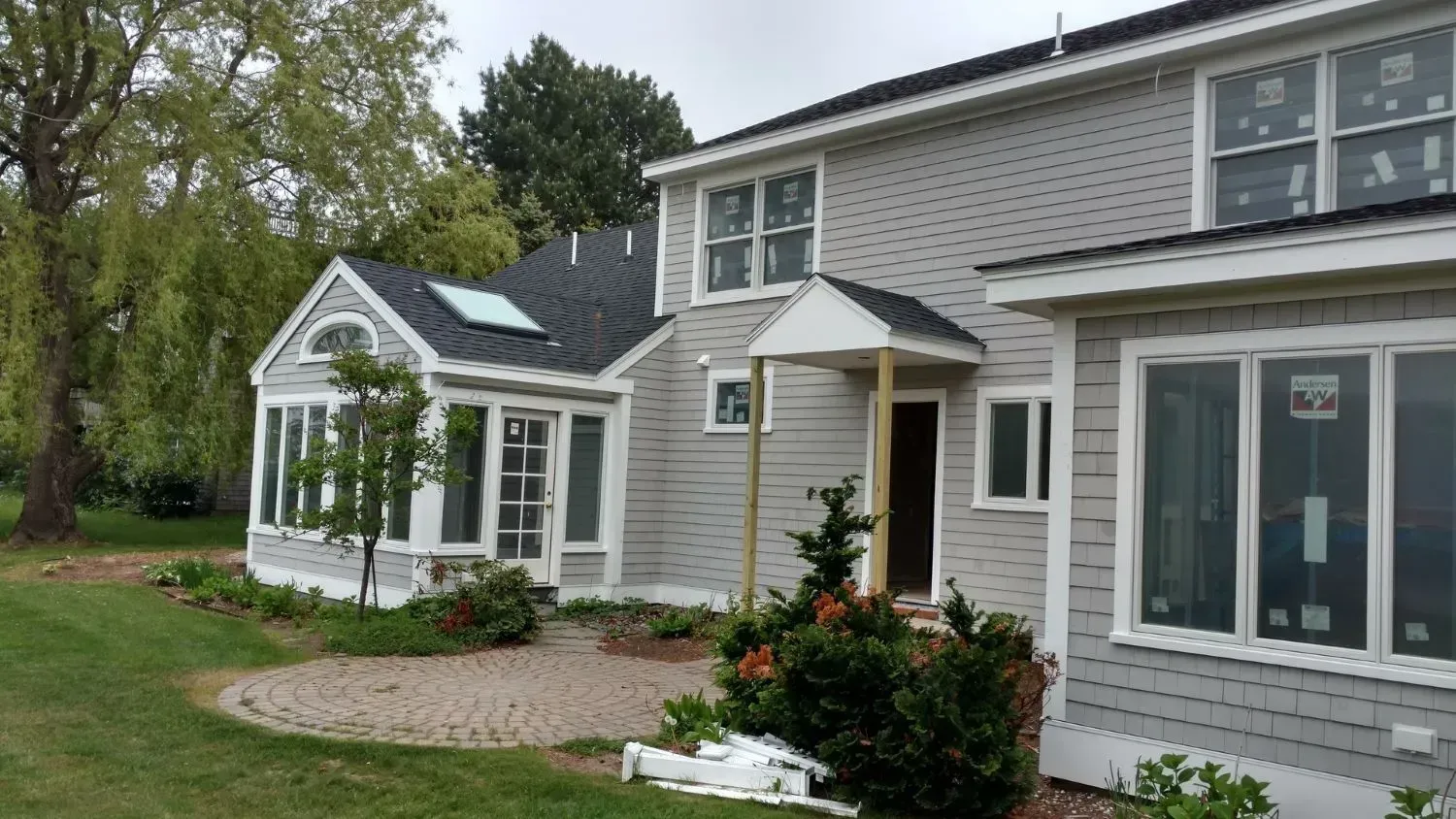 A large house with a lot of windows and a patio in front of it.