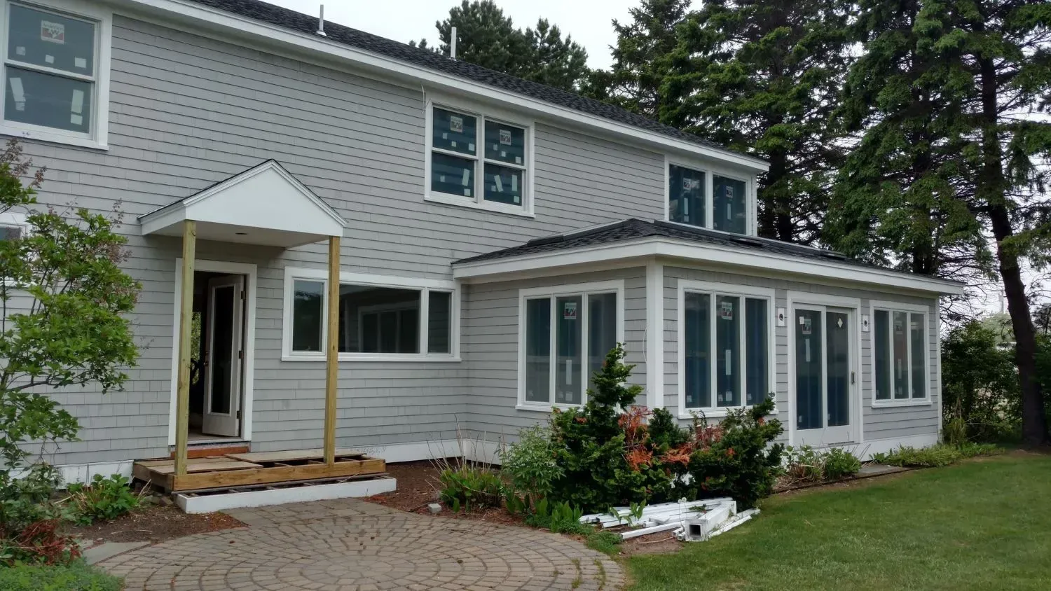 A large house with a porch and lots of windows