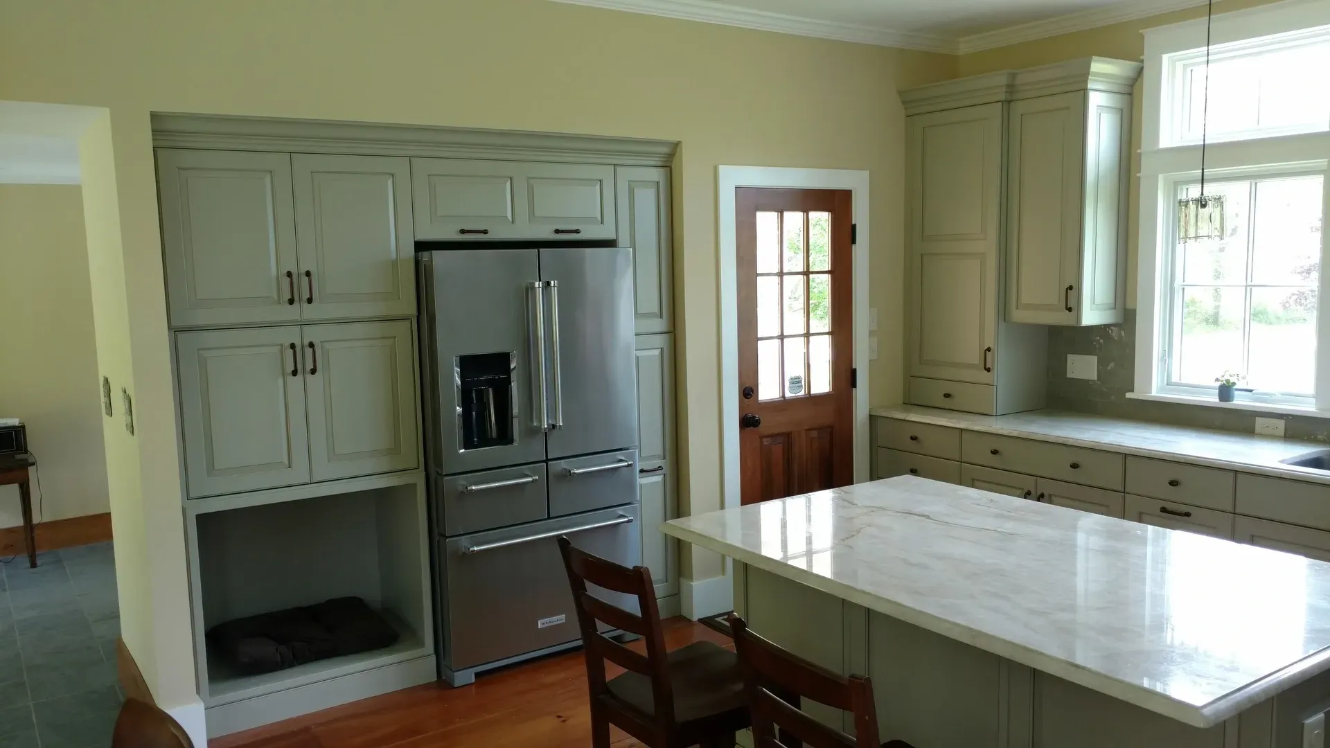 A kitchen with stainless steel appliances and a large island.