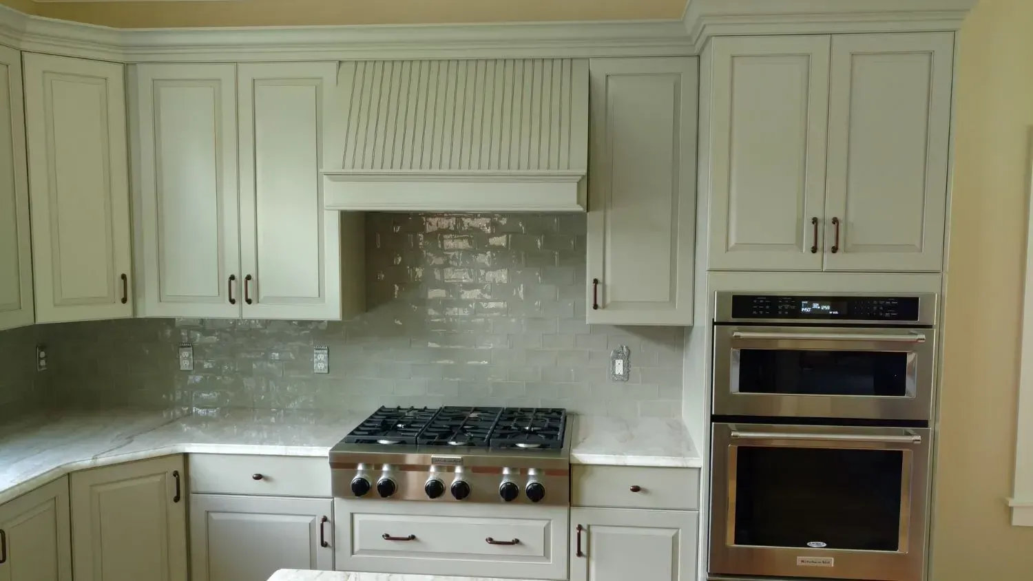 A kitchen with white cabinets and stainless steel appliances.