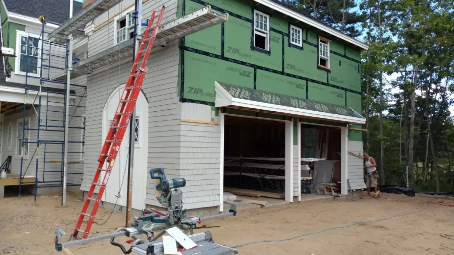 A house is being built with a garage underneath it.