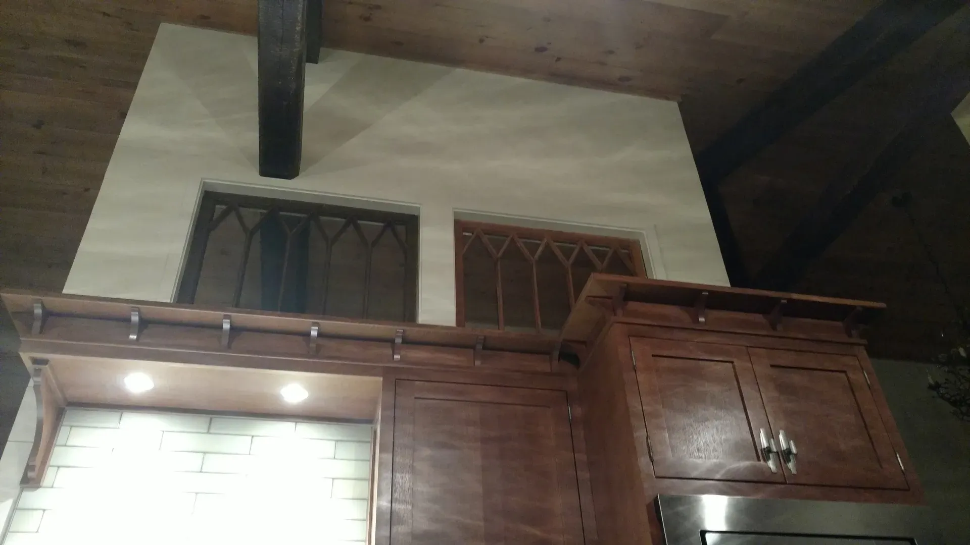 A kitchen with wooden cabinets and stainless steel appliances