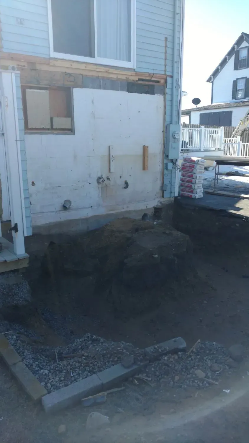 A house is being remodeled and a truck is parked in front of it.