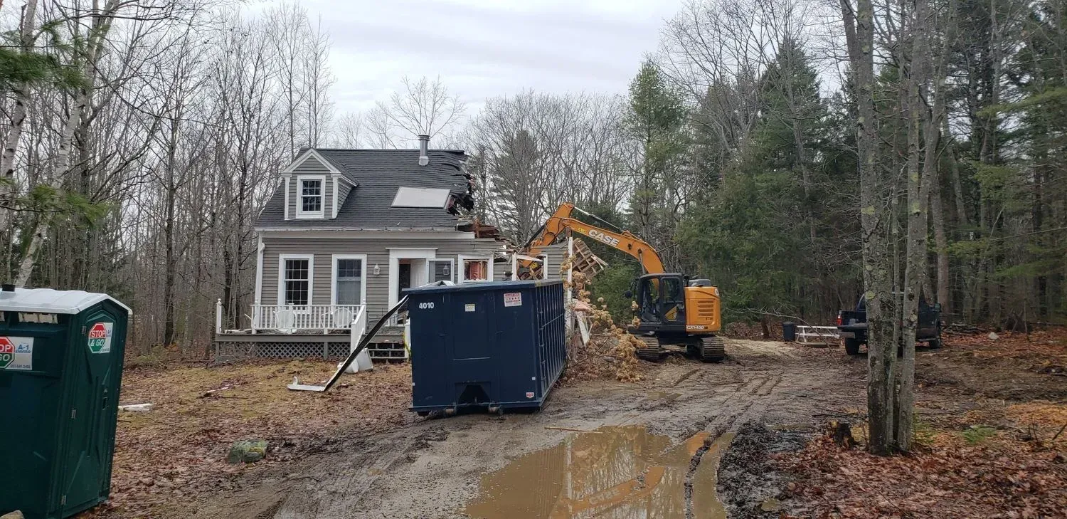 A house is being demolished in the middle of a forest.