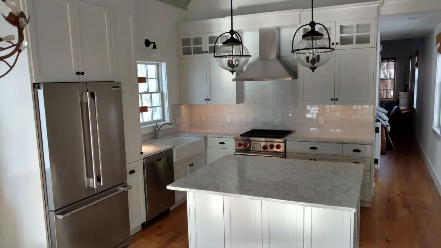 A kitchen with white cabinets and stainless steel appliances